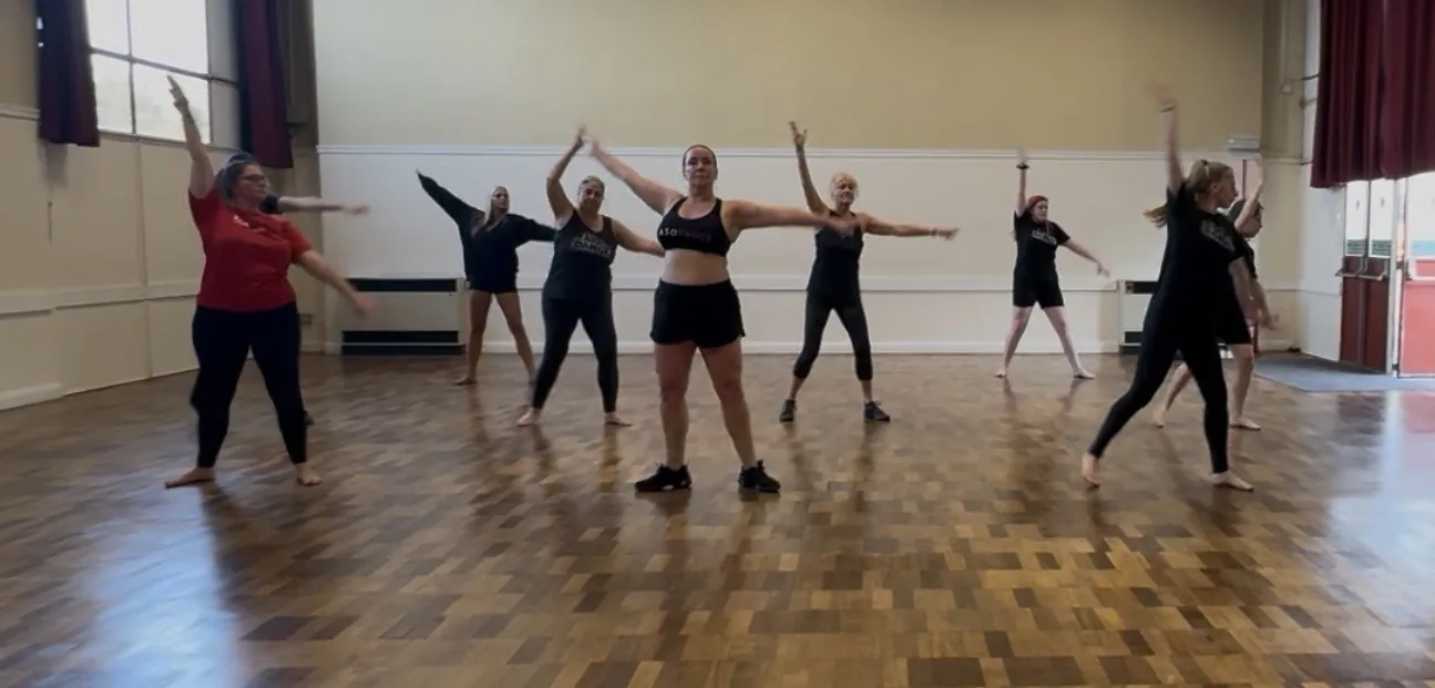 Students leaping during a studio class